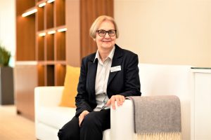 Doma, housekeeping manager sitting in the OPAL lobby posing for a professional photo